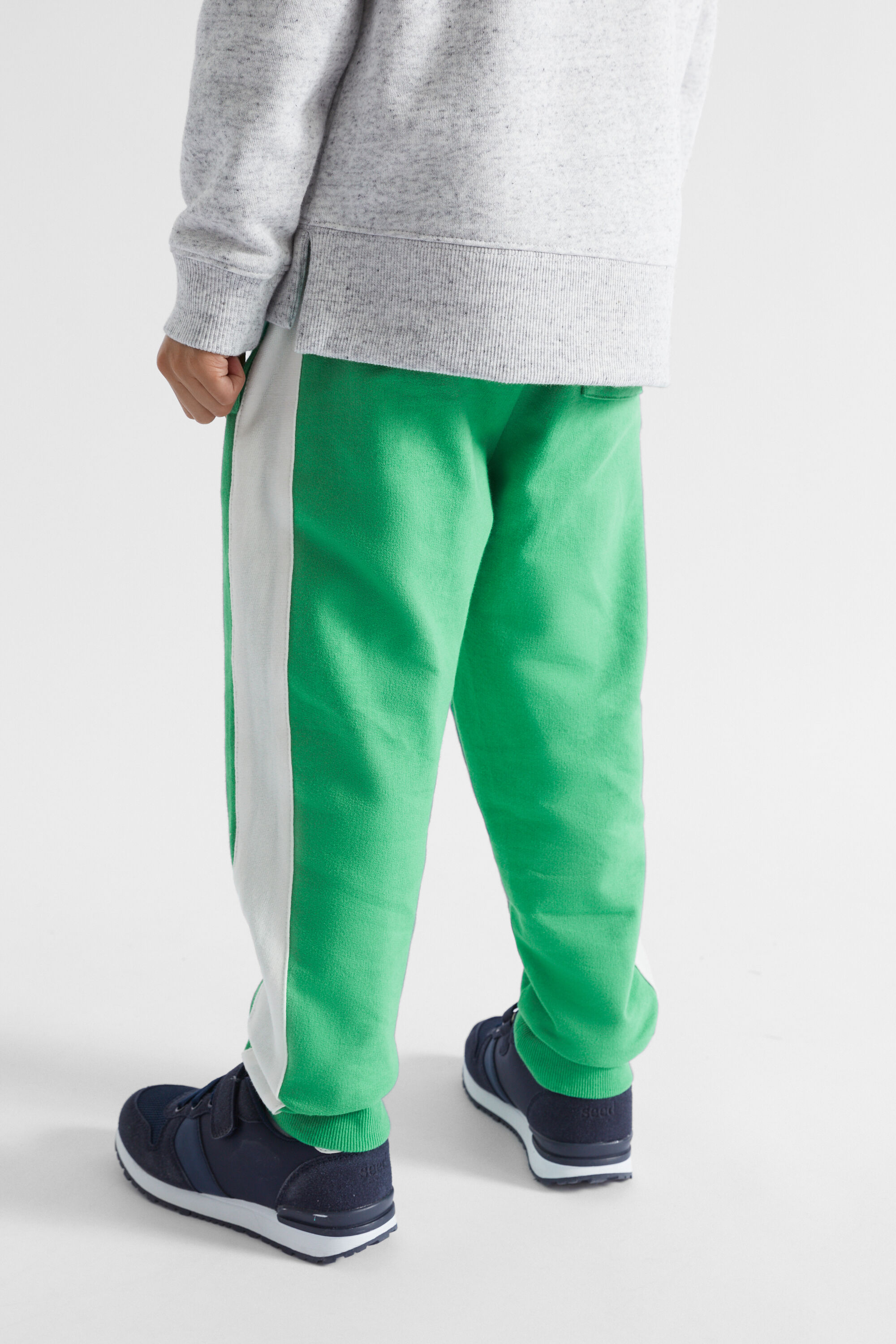 Green track pants with cheap white stripe