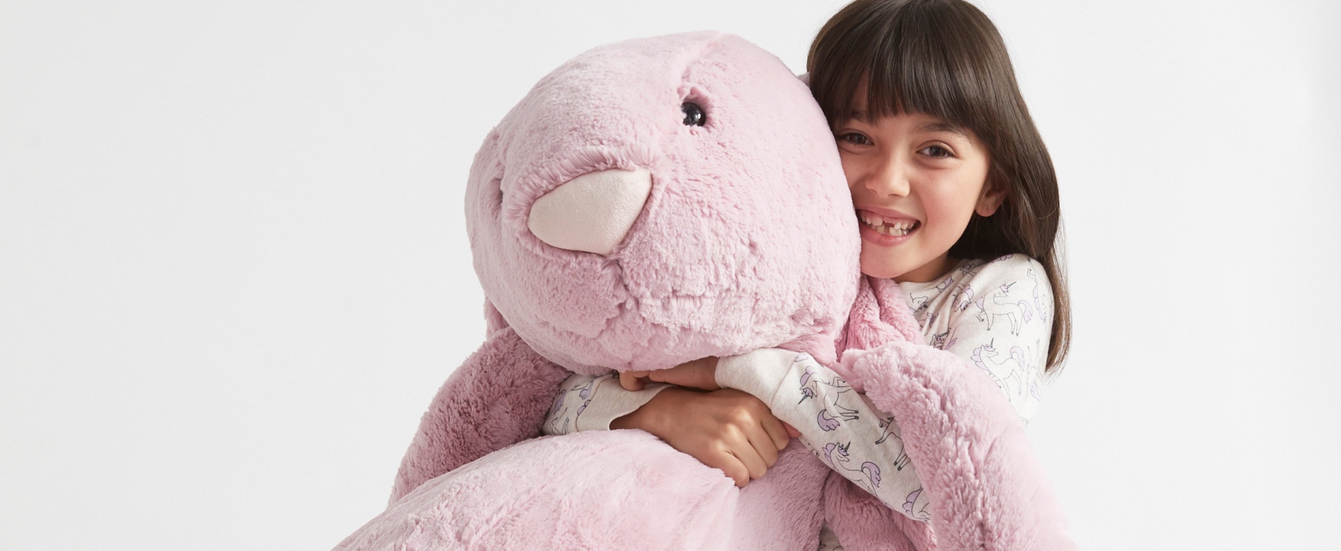 Girl holding Jellycat toys